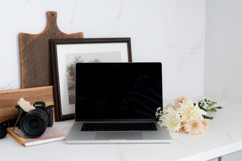 Flat lay of laptop and notebook for photography marketing and SEO planning
