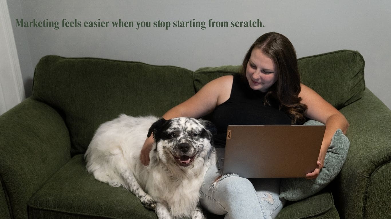 Photographer working on laptop with dog while planning content